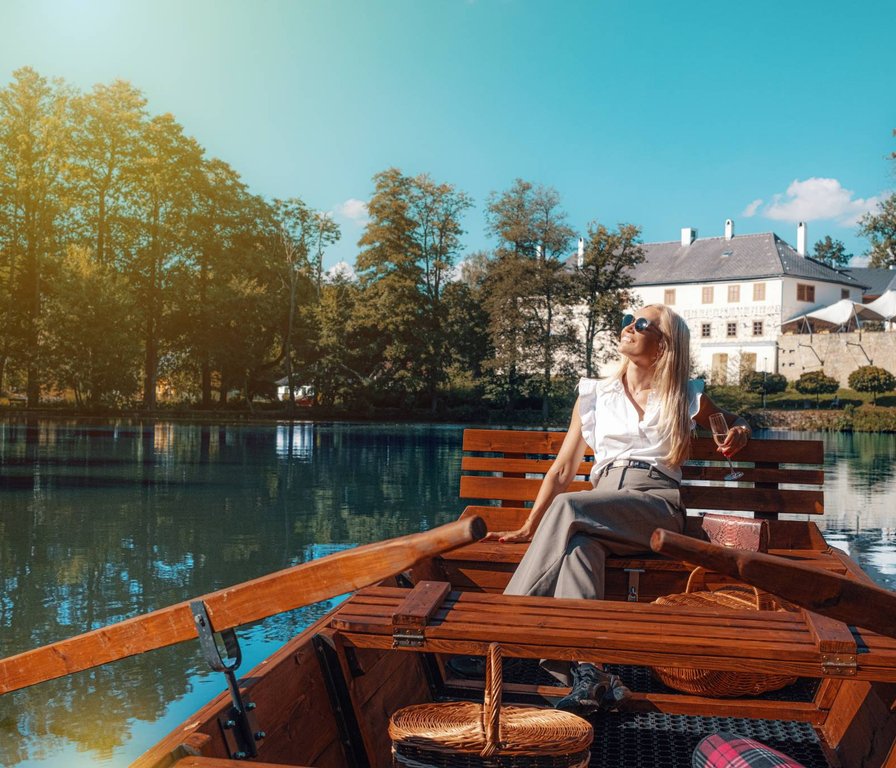 Žena na pramici na rybníku u Chateau Orlice